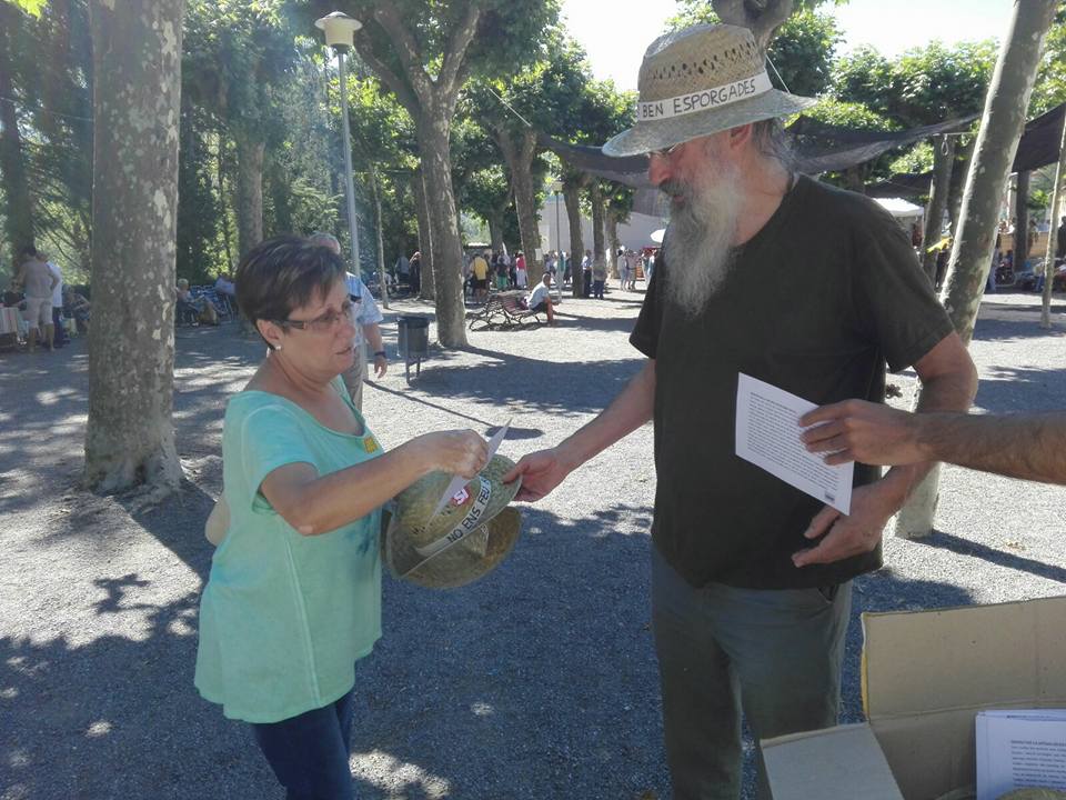 El regidor de la CUP, Santi Llagostera, donant un barret a una dona