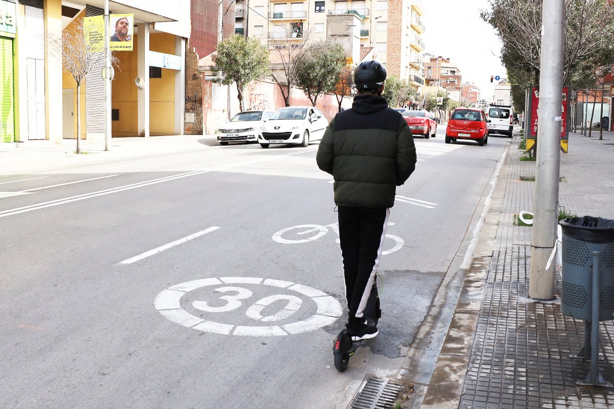 Un patinet circulant per la calçada al carrer Ramon Llull on la velocitat màxima permesa és de 30 quilòmetres per hora