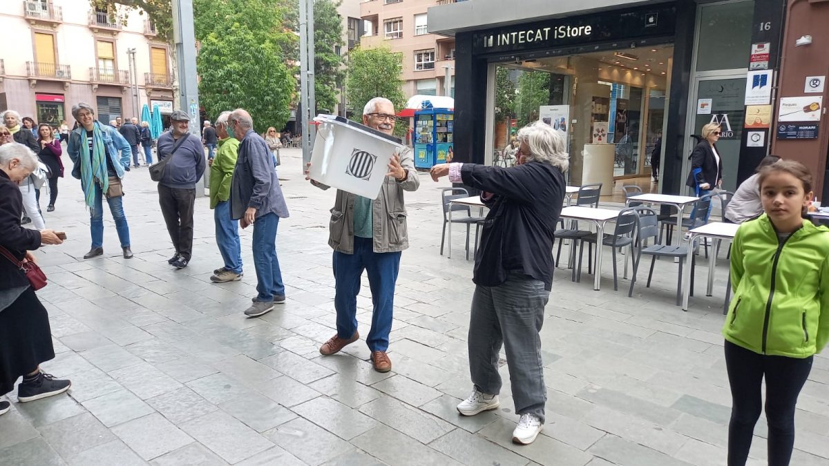 Els participants han fet córrer de mà en mà dues urnes del referèndum