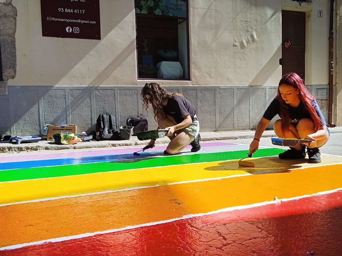 Membres del Casal de Joves la Paki pinten un pas de vianants al carrer Josep Vilaseca
